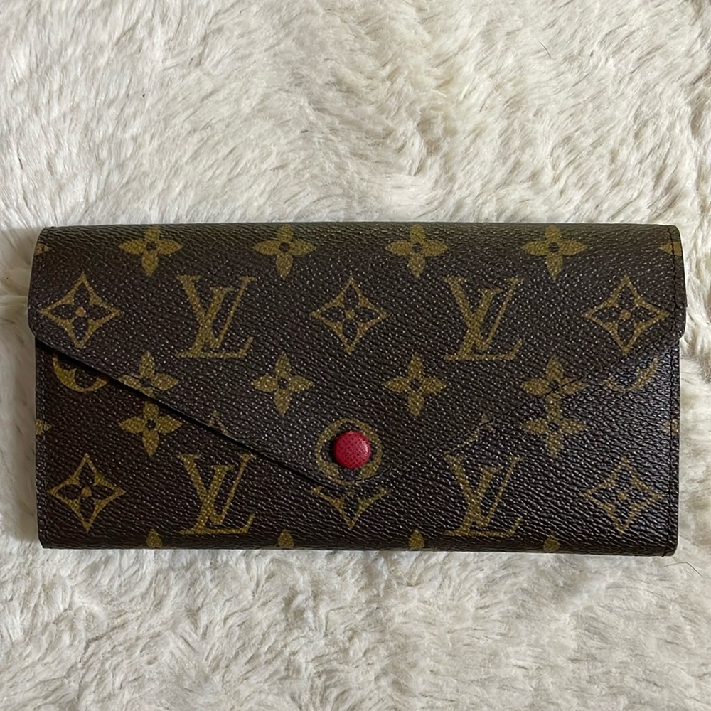 Authentic Louis Vuitton monogram wallet with red interior. Preowned.
